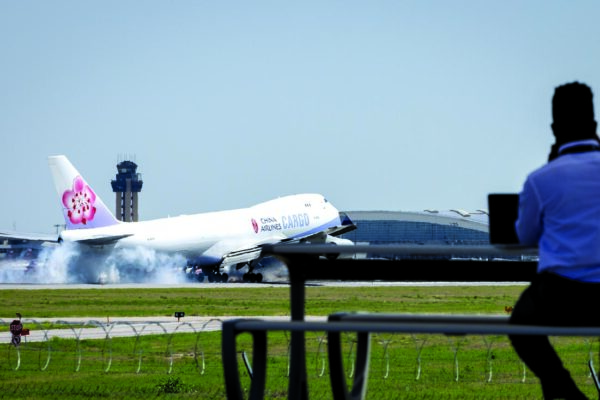 Apr.14, 2022. Zach Williams who works in operations at Dallas Love Field watches planes land at DFW as he waits for his brother to arrive. Grapevine Founders Park is situated at the location of one of Dallas/Fort Worth Airport radar stations and has a view of the two runways on the West side of the international Airport. There are pavilions and plenty of parking to allow people to enjoy the sight of commercial air traffic. Photo Ralph Lauer