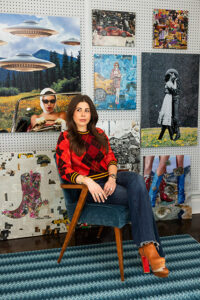 Ashley Beebe sits in front of a wall displaying her collages.