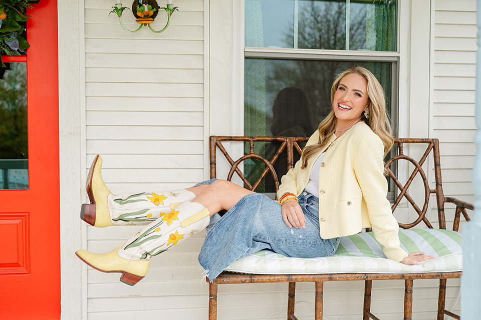 Catherine Cartie sits on the porch wearing fabulous boots