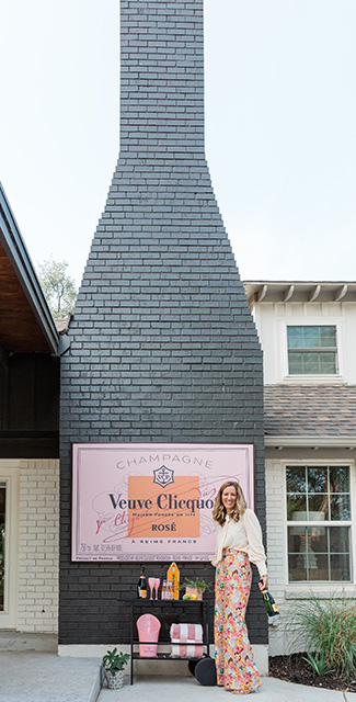Tarin Wallace stands in front of her chimney, which is shaped like a champagne bottle