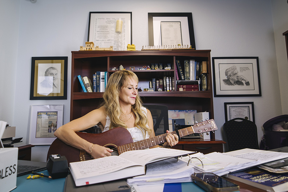 Judy Greenfeld plays her guitar