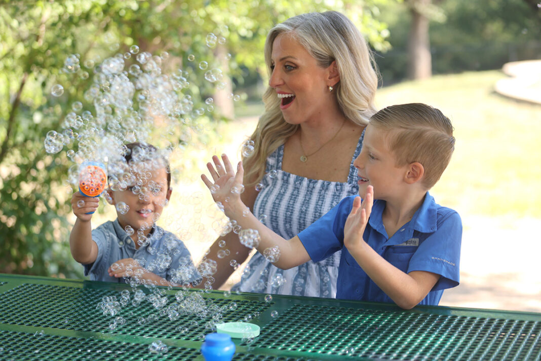 Kylette Harrison blows bubbles with her boys