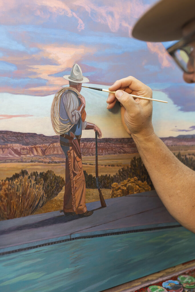 Kevin Chupik paints details on a cowboy