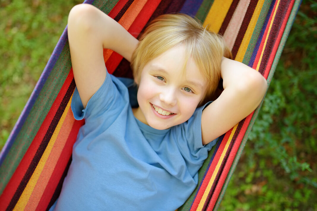 Child smiling in a hammock