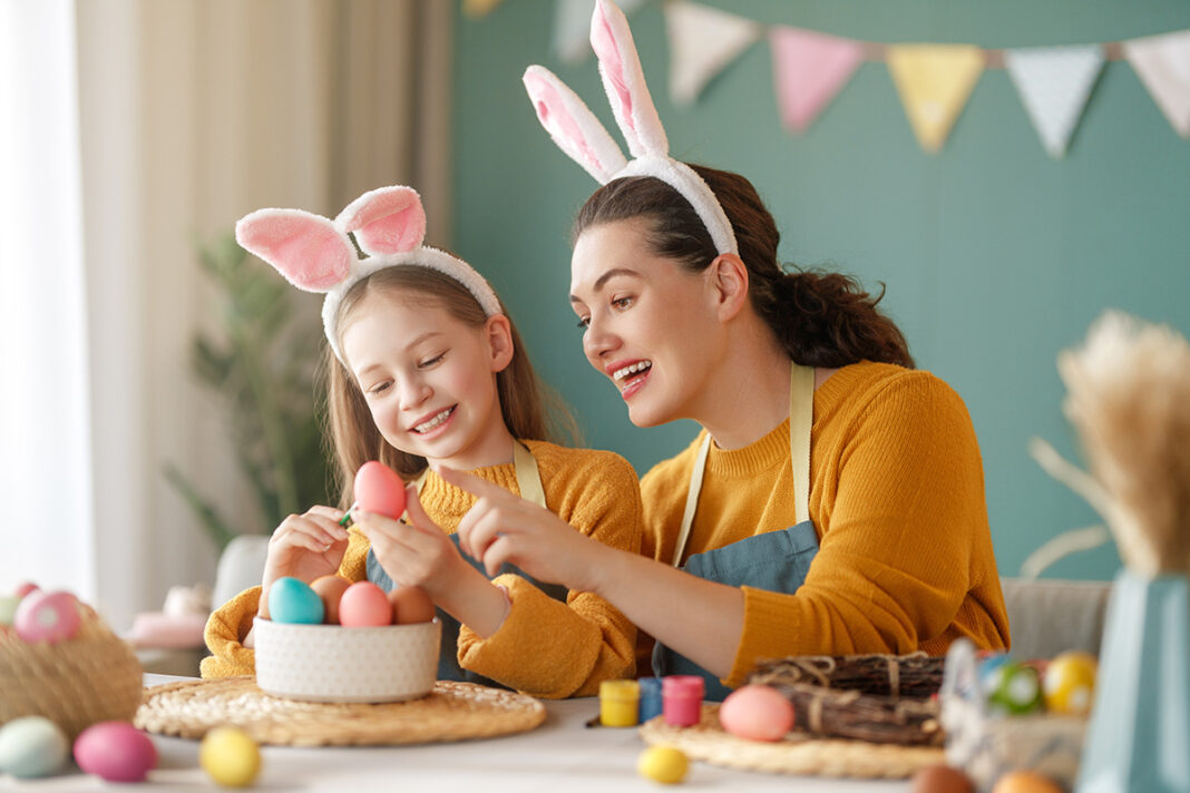 Mom and daughter fill easter eggs