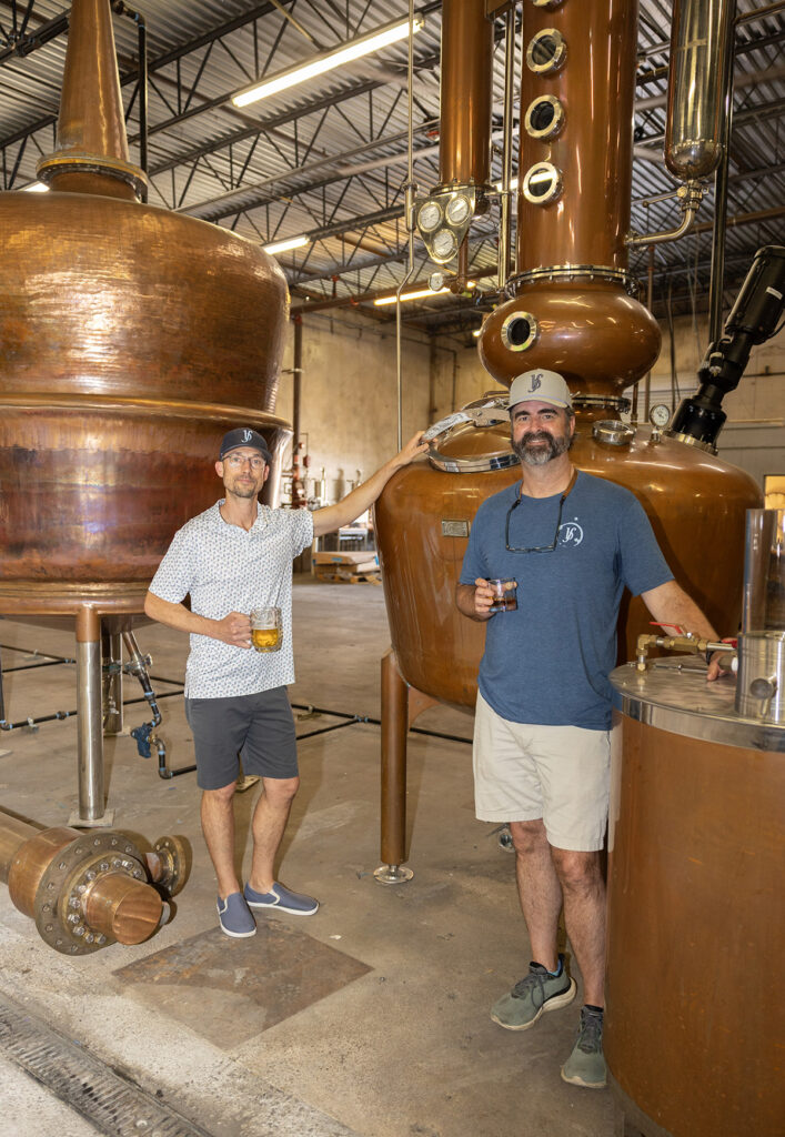 Will Rucker and Nate Swan with the custom copper stills at Blue Flag Distillery