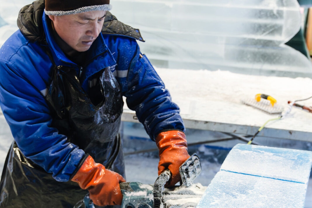 Man sawing ice for ice sculptures