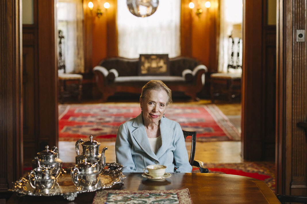 Jerre Tracy sitting at the head of a table
